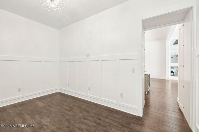 97 Marquesa Cir, Saint Johns, FL 32259 - unfurnished room with a decorative wall, dark wood-style flooring, a chandelier, and a wainscoted wall