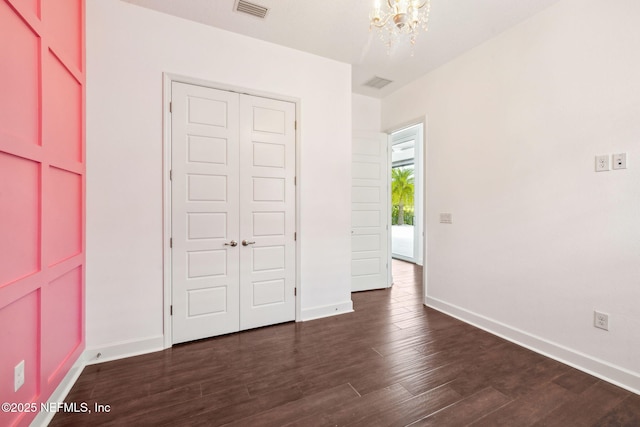 97 Marquesa Cir, Saint Johns, FL 32259 - unfurnished bedroom with a chandelier, dark wood-style flooring, and a closet