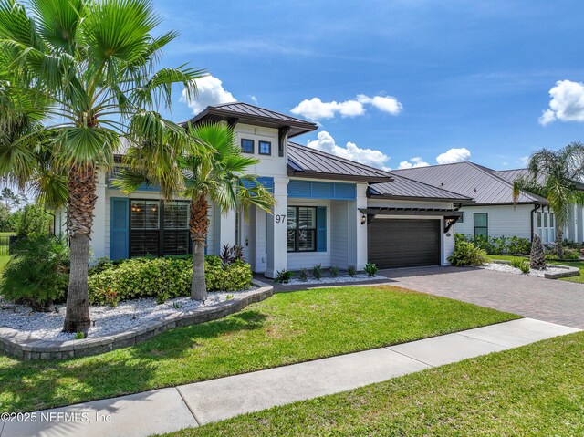 97 Marquesa Cir, Saint Johns, FL 32259 - view of front of house with a metal roof, a garage, driveway, a front lawn, and a standing seam roof