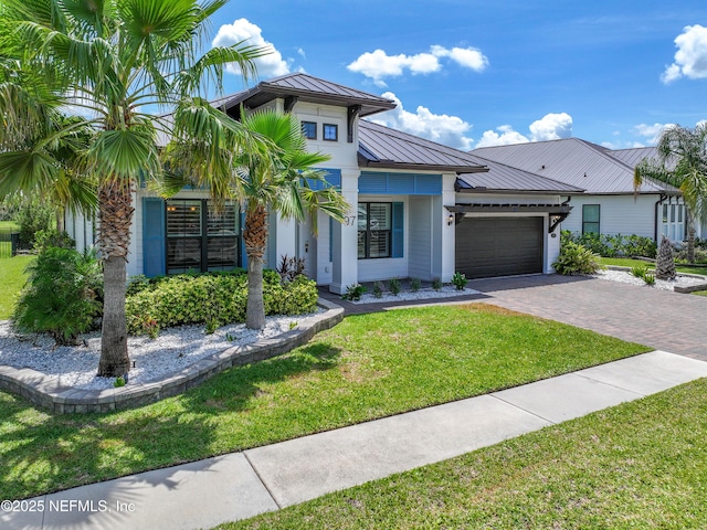 97 Marquesa Cir, Saint Johns, FL 32259 - view of front of property featuring a standing seam roof, a metal roof, a garage, a front yard, and driveway