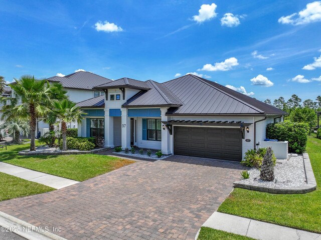 97 Marquesa Cir, Saint Johns, FL 32259 - view of front of property featuring a garage, stucco siding, a front yard, and a metal roof