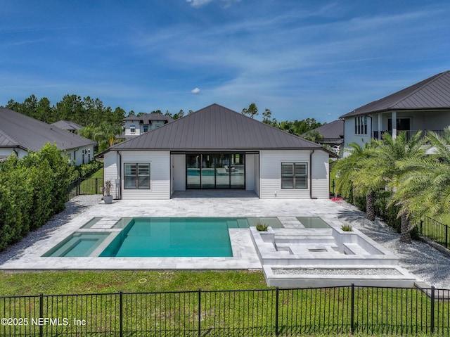 97 Marquesa Cir, Saint Johns, FL 32259 - back of house featuring a patio area, a fenced backyard, a metal roof, and a pool with connected hot tub