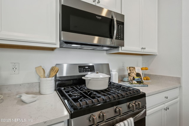 220 Killarney Ave, Saint Johns, FL 32259 - kitchen with stainless steel appliances, white cabinetry, and light stone counters