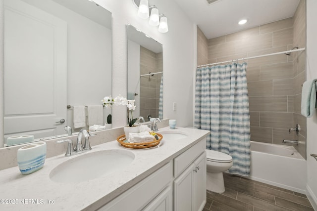 220 Killarney Ave, Saint Johns, FL 32259 - full bathroom with double vanity, shower / bath combo with shower curtain, wood finish floors, and recessed lighting
