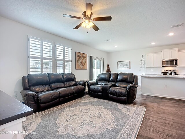 65274 Forest Glen Ln, Yulee, FL 32097 - living area with dark wood-style floors, a ceiling fan, a textured ceiling, and recessed lighting
