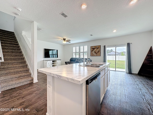 65274 Forest Glen Ln, Yulee, FL 32097 - kitchen featuring dishwasher, a sink, dark wood finished floors, a textured ceiling, and light countertops