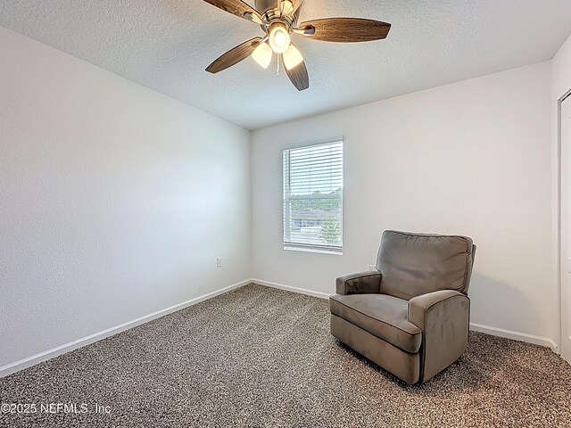 65274 Forest Glen Ln, Yulee, FL 32097 - living area with carpet floors, ceiling fan, baseboards, and a textured ceiling