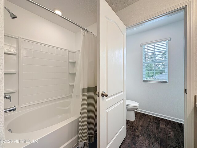 65274 Forest Glen Ln, Yulee, FL 32097 - full bathroom with wood finished floors, toilet, shower / bathtub combination with curtain, baseboards, and a textured ceiling