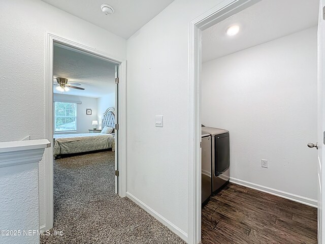 65274 Forest Glen Ln, Yulee, FL 32097 - hallway with independent washer and dryer, baseboards, and dark wood finished floors
