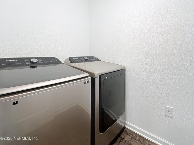 65274 Forest Glen Ln, Yulee, FL 32097 - washroom with washing machine and dryer, dark wood-style flooring, and baseboards