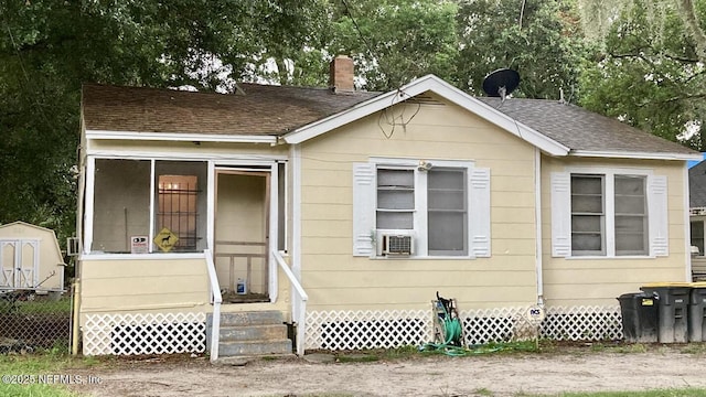 1050 Alderside St, Jacksonville, FL 32208 - bungalow featuring a chimney, a shingled roof, cooling unit, and entry steps
