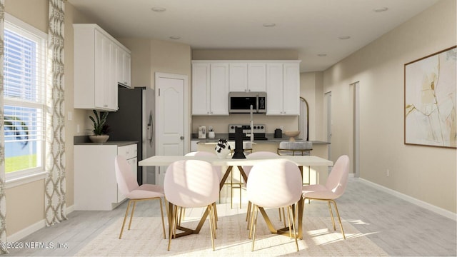 100 Round Robin Run, Saint Johns, FL 32259 - kitchen featuring appliances with stainless steel finishes, light wood-type flooring, white cabinets, and baseboards