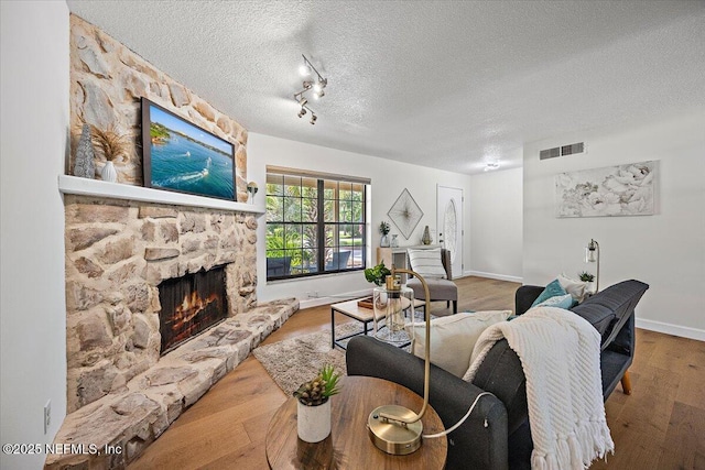 100 Palmera Ct, Ponte Vedra Beach, FL 32082 - living area with a textured ceiling, a fireplace, wood finished floors, and baseboards