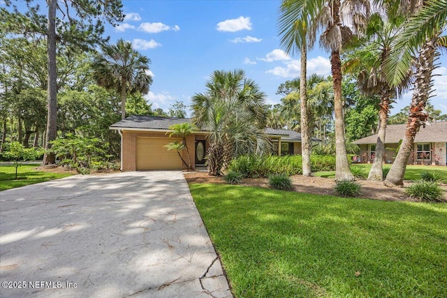 100 Palmera Ct, Ponte Vedra Beach, FL 32082 - obstructed view of property with a garage, concrete driveway, a front yard, and brick siding