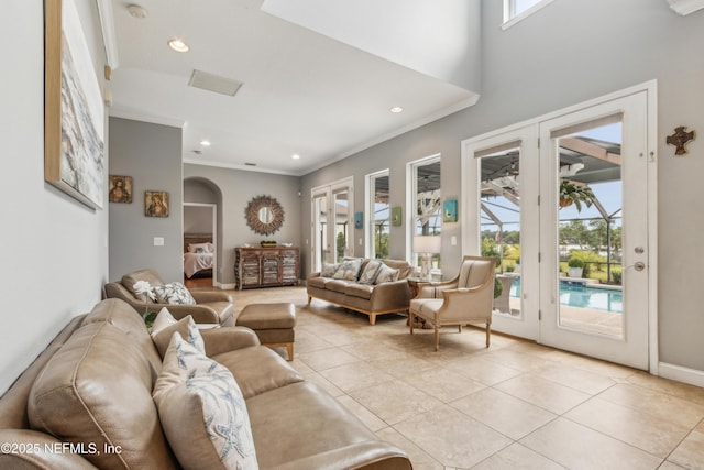 96266 Dowling Dr, Yulee, FL 32097 - living area with arched walkways, light tile patterned floors, ornamental molding, recessed lighting, and baseboards