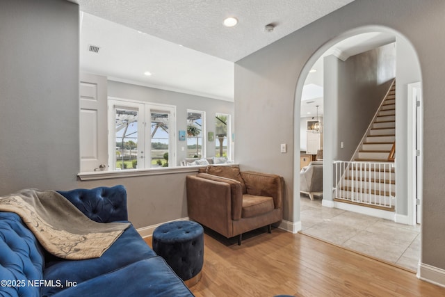 96266 Dowling Dr, Yulee, FL 32097 - living area with arched walkways, stairs, wood finished floors, baseboards, and recessed lighting