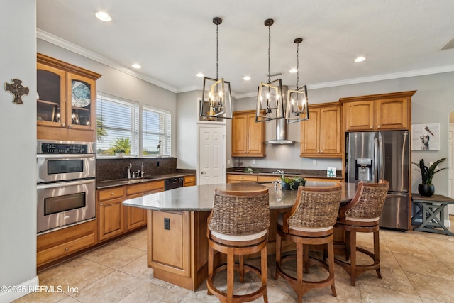 96266 Dowling Dr, Yulee, FL 32097 - kitchen with appliances with stainless steel finishes, a sink, wall chimney exhaust hood, a chandelier, and an island with sink
