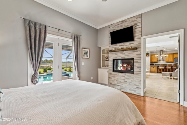 96266 Dowling Dr, Yulee, FL 32097 - bedroom with access to outside, light wood finished floors, a tiled fireplace, ornamental molding, and recessed lighting