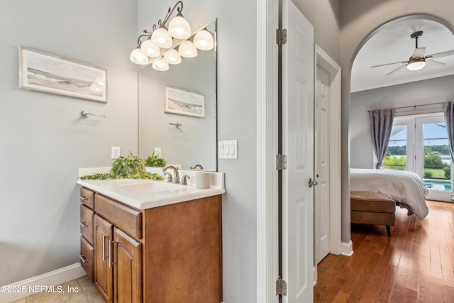 96266 Dowling Dr, Yulee, FL 32097 - ensuite bathroom with vanity, ceiling fan, baseboards, ornamental molding, and wood finished floors