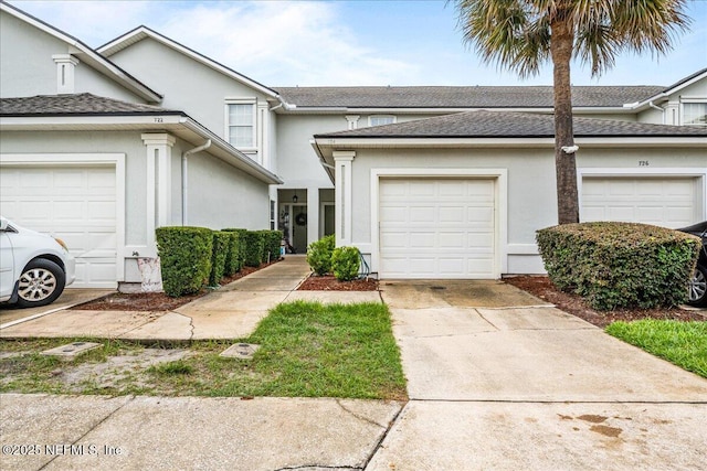 724 Middle Branch Way, Fruit Cove, FL 32259 - view of property featuring concrete driveway, stucco siding, an attached garage, and a shingled roof