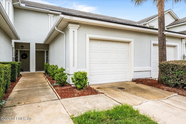 724 Middle Branch Way, Fruit Cove, FL 32259 - doorway to property with stucco siding, concrete driveway, an attached garage, and roof with shingles
