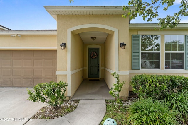 4916 Creek Bluff Ln, Middleburg, FL 32068 - view of exterior entry with stucco siding and a garage