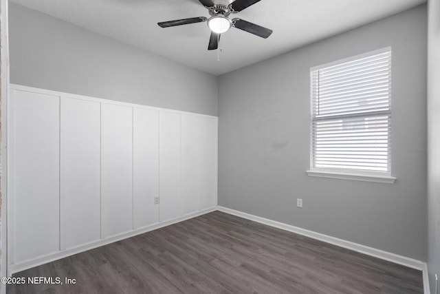4916 Creek Bluff Ln, Middleburg, FL 32068 - empty room featuring dark wood-style floors, a ceiling fan, and baseboards