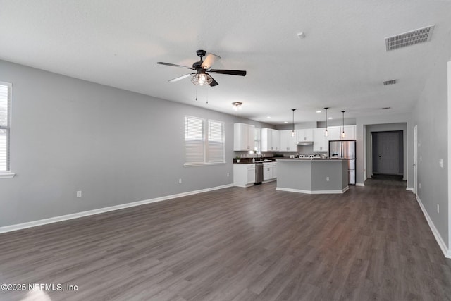 4916 Creek Bluff Ln, Middleburg, FL 32068 - unfurnished living room featuring ceiling fan, dark wood finished floors, baseboards, and a textured ceiling