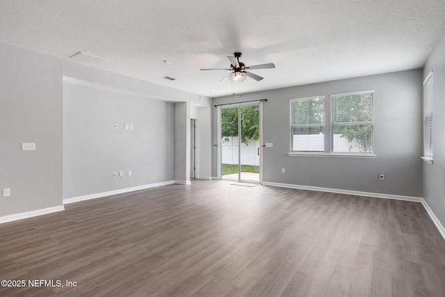 4916 Creek Bluff Ln, Middleburg, FL 32068 - spare room featuring a ceiling fan, dark wood-style flooring, baseboards, and a textured ceiling