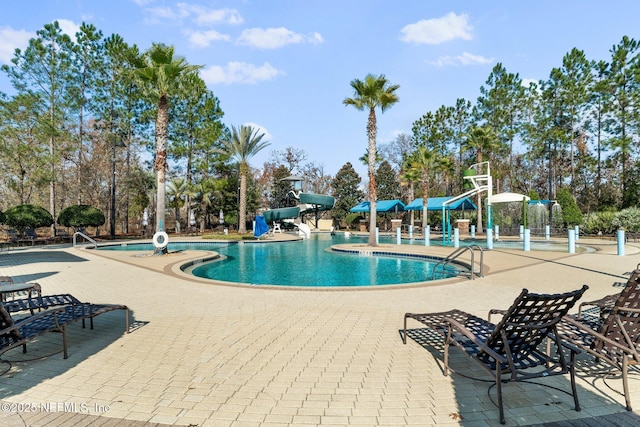 4916 Creek Bluff Ln, Middleburg, FL 32068 - community pool with a water slide, a patio, and view of scattered trees