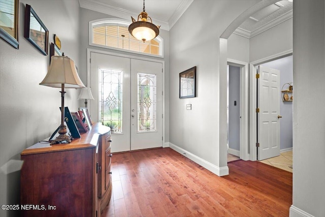 1714 Chatham Village Dr, Fleming Island, FL 32003 - entrance foyer featuring ornamental molding, arched walkways, and light wood finished floors