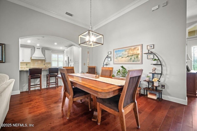 1714 Chatham Village Dr, Fleming Island, FL 32003 - dining space featuring crown molding, dark wood finished floors, arched walkways, a chandelier, and recessed lighting