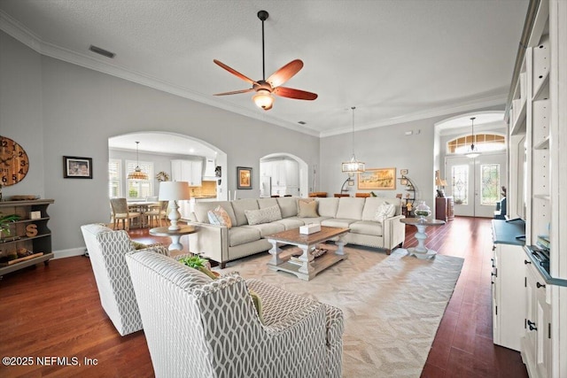 1714 Chatham Village Dr, Fleming Island, FL 32003 - living area featuring arched walkways, a ceiling fan, wood finished floors, healthy amount of natural light, and ornamental molding