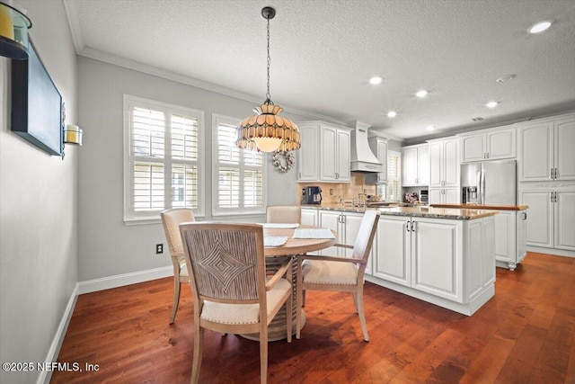 1714 Chatham Village Dr, Fleming Island, FL 32003 - dining area with a textured ceiling, healthy amount of natural light, recessed lighting, ornamental molding, and dark wood-type flooring
