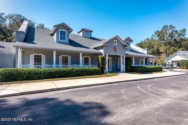 1714 Chatham Village Dr, Fleming Island, FL 32003 - view of front facade featuring covered porch and a chimney