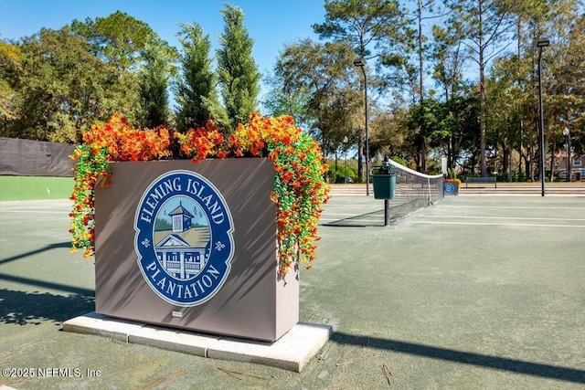 1714 Chatham Village Dr, Fleming Island, FL 32003 - surrounding community with a tennis court and uncovered parking