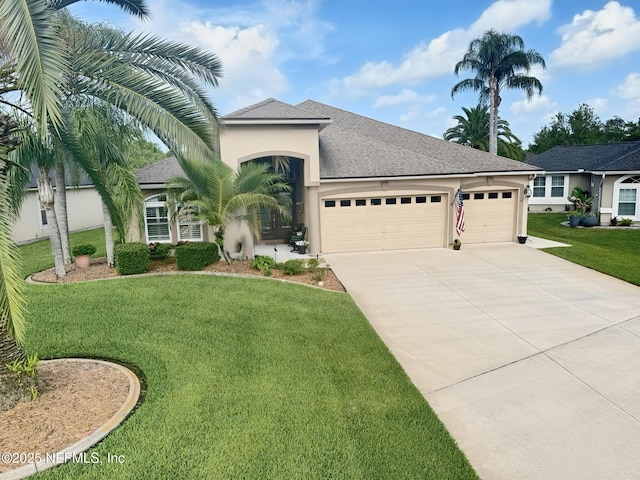 1714 Chatham Village Dr, Fleming Island, FL 32003 - ranch-style house with an attached garage, concrete driveway, stucco siding, a front yard, and roof with shingles
