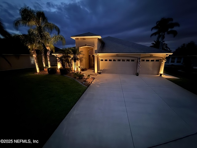 1714 Chatham Village Dr, Fleming Island, FL 32003 - mediterranean / spanish house featuring a garage, concrete driveway, and a lawn