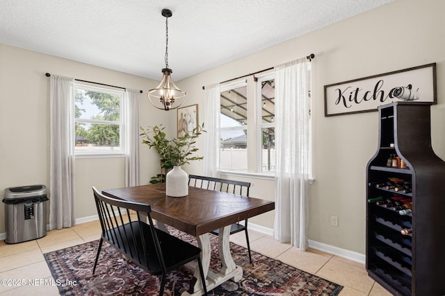 3172 Treeside Ln, Green Cove Springs, FL 32043 - dining area featuring a chandelier, light tile patterned floors, a textured ceiling, baseboards, and beverage cooler