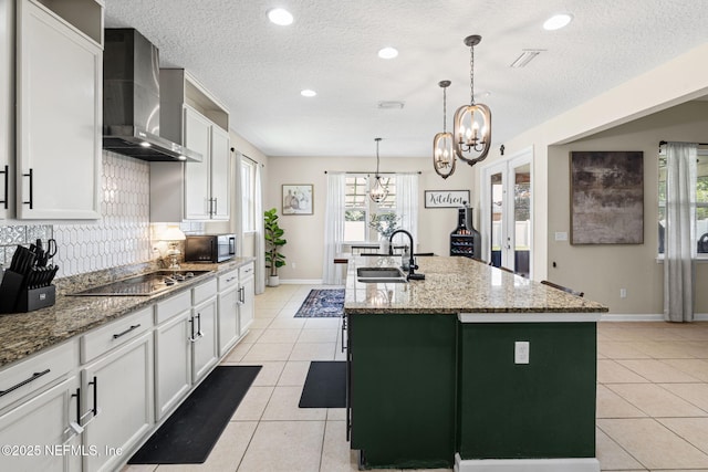 3172 Treeside Ln, Green Cove Springs, FL 32043 - kitchen with a sink, wall chimney exhaust hood, black appliances, an island with sink, and light tile patterned floors