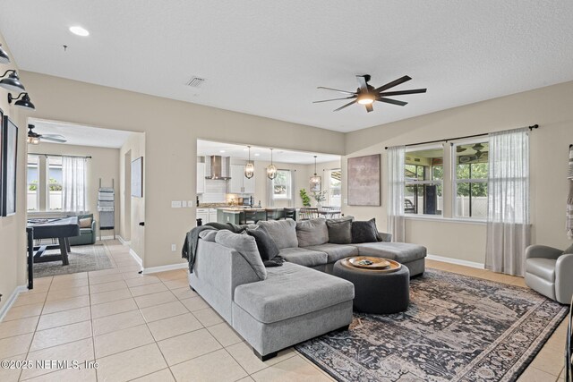 3172 Treeside Ln, Green Cove Springs, FL 32043 - living area featuring ceiling fan, light tile patterned floors, and baseboards