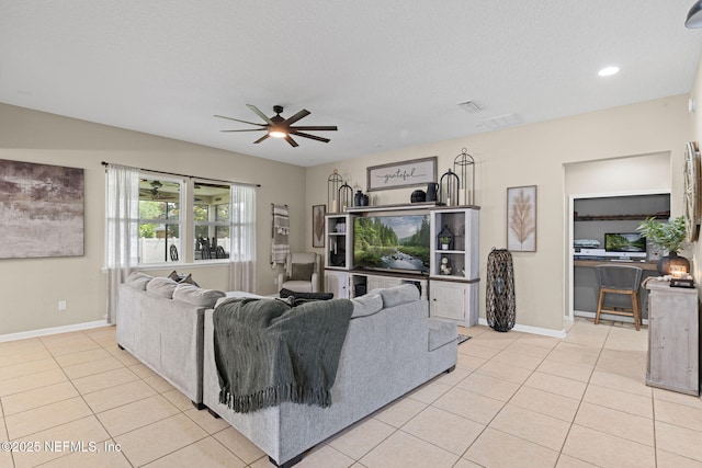 3172 Treeside Ln, Green Cove Springs, FL 32043 - living room with a ceiling fan, light tile patterned flooring, baseboards, and a textured ceiling