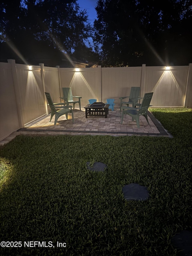 3172 Treeside Ln, Green Cove Springs, FL 32043 - yard at night featuring a patio