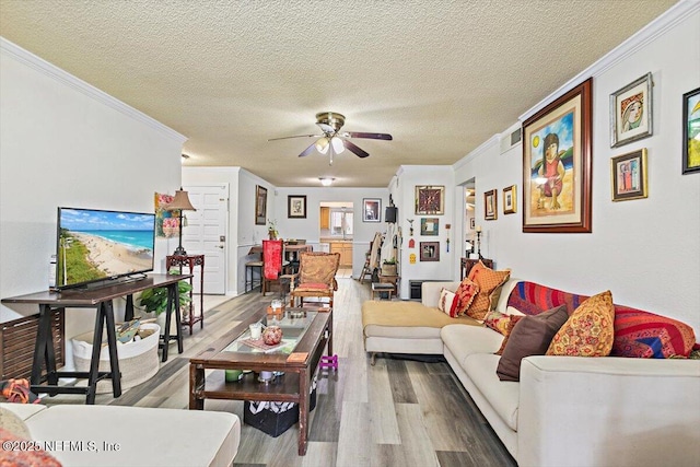 6655 Bell Tower Ct Unit 1, Jacksonville, FL 32217 - living area featuring wood finished floors, ornamental molding, ceiling fan, and a textured ceiling