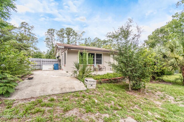 1165 5th St, Macclenny, FL 32063 - back of property featuring a patio and a shingled roof