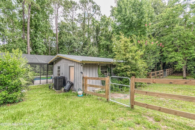 1165 5th St, Macclenny, FL 32063 - view of outdoor structure with a pool, a gate, and central air condition unit
