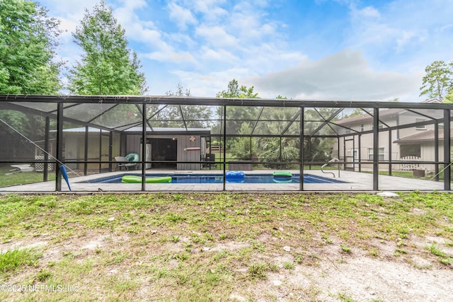 1165 5th St, Macclenny, FL 32063 - back of house with an outdoor pool, glass enclosure, and a patio area