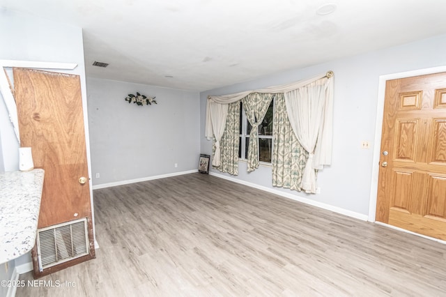 1165 5th St, Macclenny, FL 32063 - unfurnished living room featuring wood finished floors and baseboards