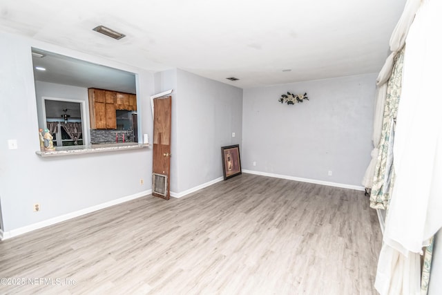 1165 5th St, Macclenny, FL 32063 - unfurnished living room featuring wood finished floors and baseboards
