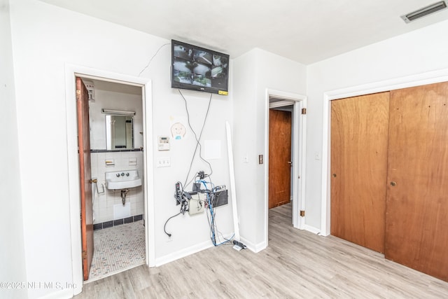 1165 5th St, Macclenny, FL 32063 - corridor featuring wood finished floors, a sink, and baseboards
